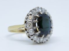 An 18ct sapphire and diamond cluster ring, size L.