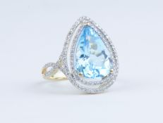 A 14k yellow gold and diamond ring set with pear cut blue topaz approx 7.58ct, diamonds approx 0.