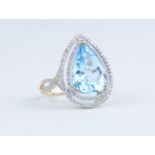 A 14k yellow gold and diamond ring set with pear cut blue topaz approx 7.58ct, diamonds approx 0.
