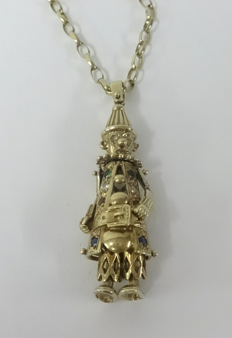 A 9ct clown pendant on a 9ct chain, approx 26.80gms.