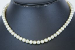 A Mikimoto pearl necklace in original box.