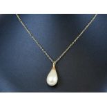A pearl single stone necklace set on a fine gold chain, the pearl approx 10mm diameter.