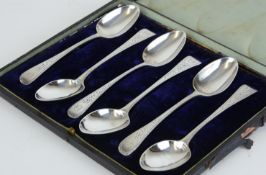 A set of six Victorian silver teaspoons with bright cut decoration, cased.