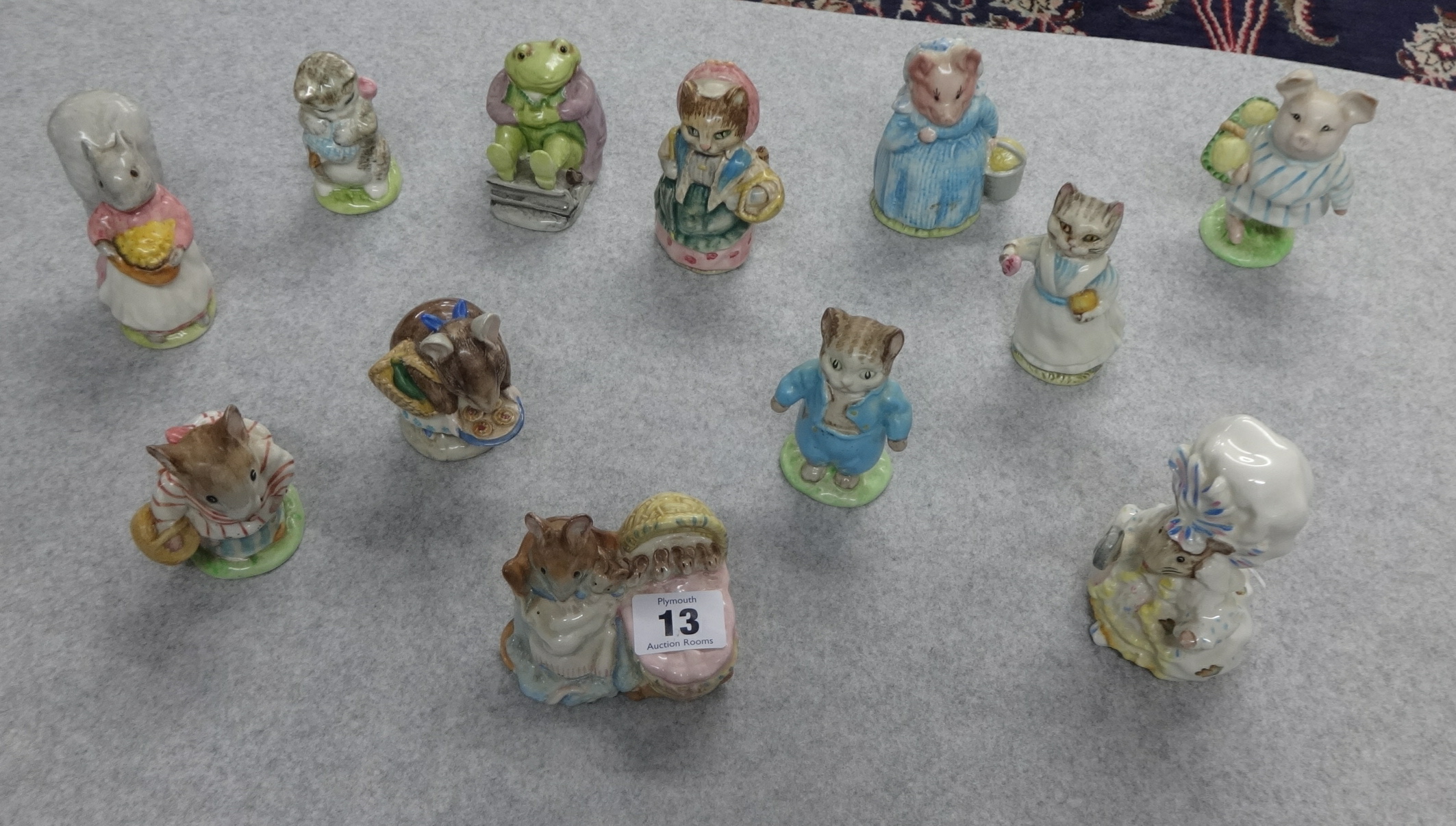 A collection of twelve Beswick Beatrix Potter figures including Hunca Munca, Tom Kitten, Little