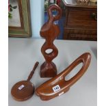Two wood carvings and a wood backed and handled mirror.