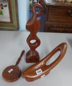 Two wood carvings and a wood backed and handled mirror.