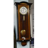 A Vienna style mahogany case wall clock with single weight and pendulum.