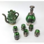 A green glass and silver overlay sherry set together with a Palissy style teapot in the form of a