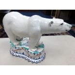 Modern pottery group of a polar bear indistinctly signed, height 24cm.