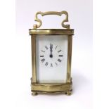 A brass cased carriage clock with platform escapement enamel dial with roman numerals, height 17cm