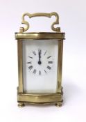 A brass cased carriage clock with platform escapement enamel dial with roman numerals, height 17cm