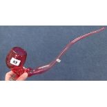 A large Victorian cranberry glass pipe, approx 40cm long.