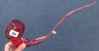 A large Victorian cranberry glass pipe, approx 40cm long.