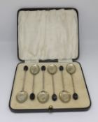 A set six silver and enamelled 'coffee bean' spoons, cased.