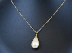 A pearl single stone necklace set on a fine gold chain, the pearl approx 10mm diameter.