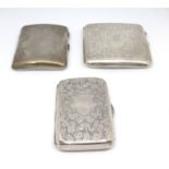 Three silver cigarette cases.