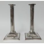 A pair of silver plated column candlesticks, height 24cm.
