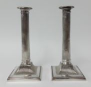 A pair of silver plated column candlesticks, height 24cm.