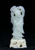 An antique Chinese white jade carving of standing robed figure on a ivory base carved with Lingzi