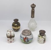 A collection of five scent bottles and jars including porcelain and silver mounted, Charles May