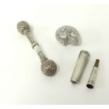 A novelty silver shell box, continental silver baby rattle and a silver cased cigarette holder.