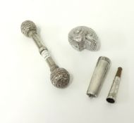 A novelty silver shell box, continental silver baby rattle and a silver cased cigarette holder.
