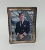 A silver rectangular photo frame, 21cm x 16cm.