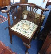 A Georgian oak corner chair with splat backs, turned supports and tapestry seat.