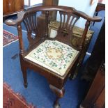 A Georgian oak corner chair with splat backs, turned supports and tapestry seat.