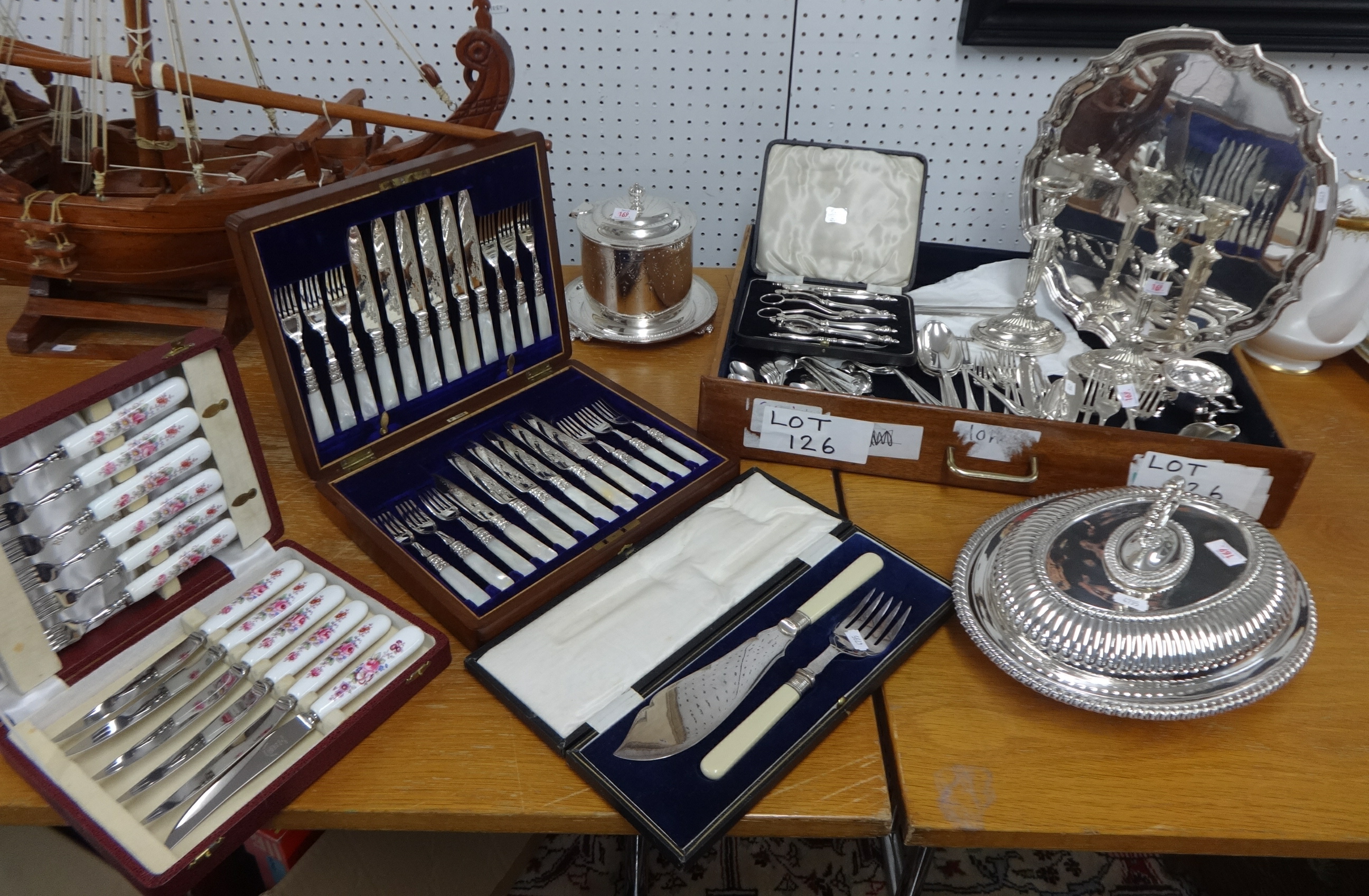 A collection of silver plated wares including entre dishes, biscuiteer, pair of candle sticks,