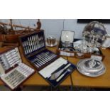 A collection of silver plated wares including entre dishes, biscuiteer, pair of candle sticks,