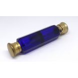 Sampson & Morden, London, a Victorian blue glass double end scent bottle with silver gilt tops,
