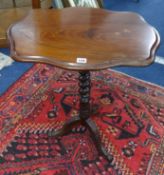 A Victorian mahogany tripod wine table with barley twist support.