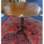 A Victorian mahogany tripod wine table with barley twist support.