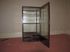 A shop display cabinet, with sign 'Ingersoll Watches and Clocks', poor condition.