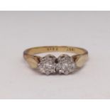 An 18ct two stone diamond ring, size P.