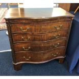 A mahogany serpentine four drawer bachelors chest with brushing slide of Georgian style, width