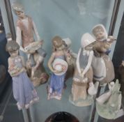 Four Nao porcelain figures, two Lladro figures and an unmarked figure of a young man with lambs. (