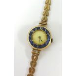 A ladies watch with enamelled dial and 9ct bracelet (21.7g).