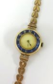 A ladies watch with enamelled dial and 9ct bracelet (21.7g).