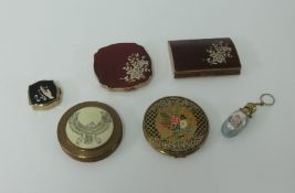 A collection of five various compacts including Melissa and a glass and gilt scent bottle.