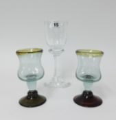 An early 20th century large drinking glass, height 20cm and a pair of other coloured drinking