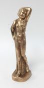 A bronze sculpture, standing nude.
