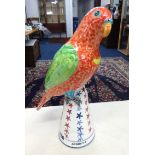 Modern pottery group of a Parrot indistinctly signed, the base marked 'Polly achieves stable