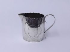 A Georgian silver cream jug marked G? TH with engraved decoration, height 9cms approx 4.23 oz