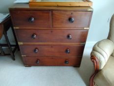 A mahogany two part military chest with brass mounts.