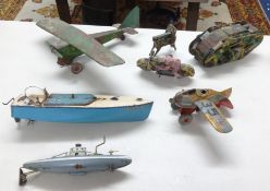 A collection of vintage tinplate toys including aircraft, Japanese clockwork camouflaged