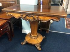 A Victorian rosewood fold over pedestal card table.