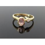 A yellow metal dress ring set with a single diamond and another coloured stone, size K.