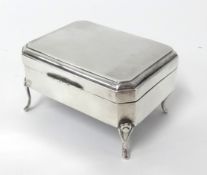 A silver box on four legs, marked 'Chester Assay' 1914, by James Deakin & Sons, total weight 3.